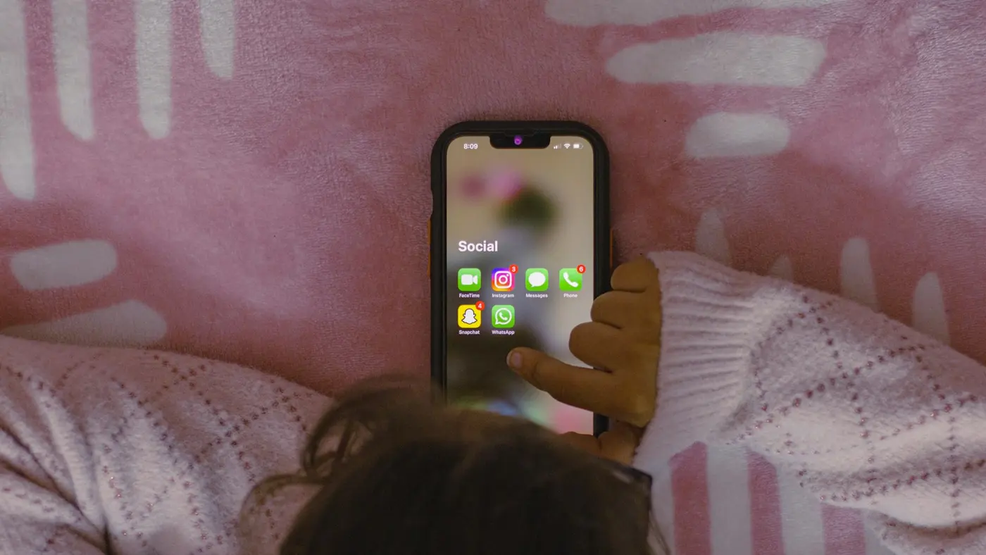 A customer with WhatsApp open on their phone